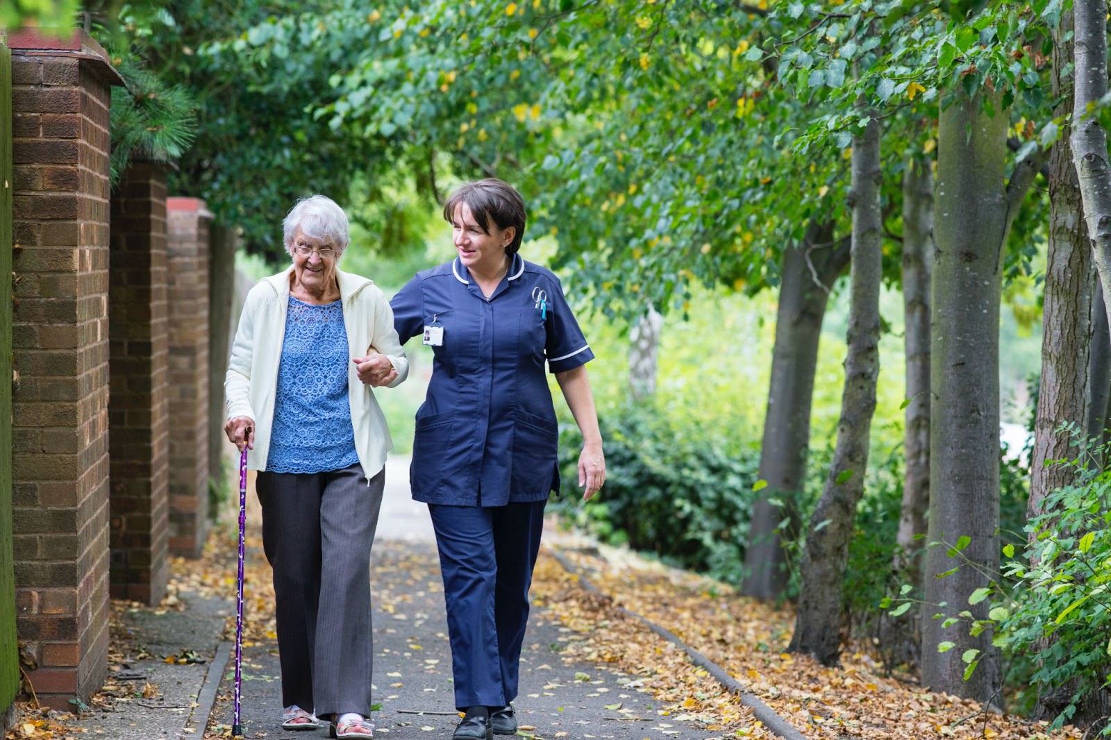 Caretaker walking with senior citizen